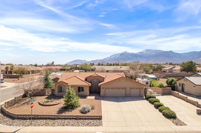 view of front of home with stucco siding, driveway, fence, a garage, and a tiled roof