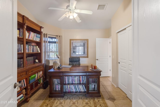 office area with light tile patterned floors, visible vents, and ceiling fan