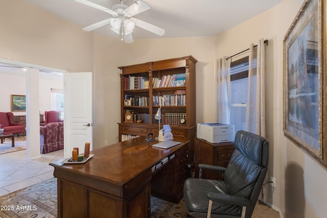 home office with light tile patterned floors and a ceiling fan