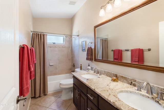 bathroom with double vanity, visible vents, tile patterned floors, and a sink