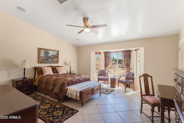 bedroom with lofted ceiling, light tile patterned floors, and ceiling fan