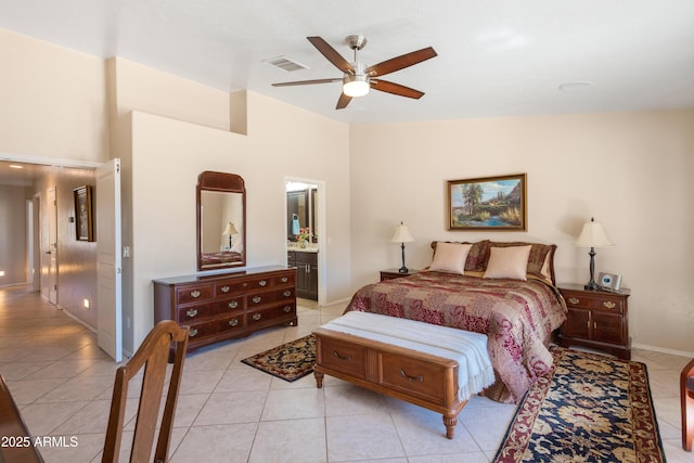 bedroom with visible vents, baseboards, ceiling fan, light tile patterned floors, and ensuite bathroom