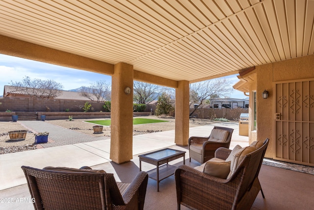 view of patio featuring an outdoor hangout area and a fenced backyard