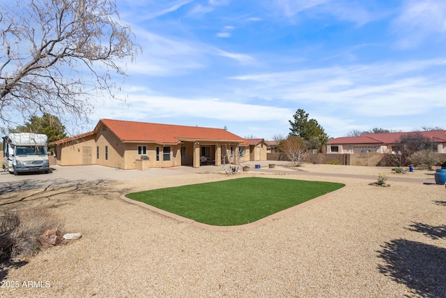 back of house featuring a tile roof and stucco siding