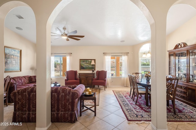 living room featuring light tile patterned floors, a ceiling fan, and visible vents