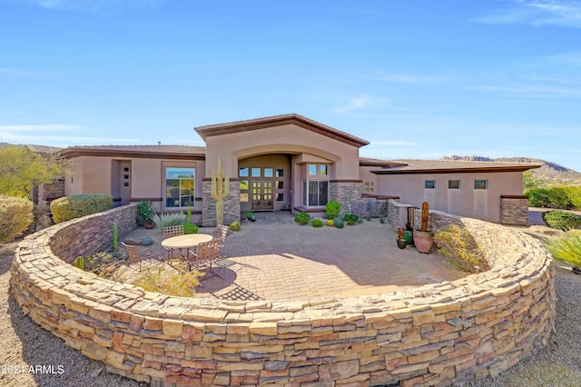 rear view of property featuring a patio