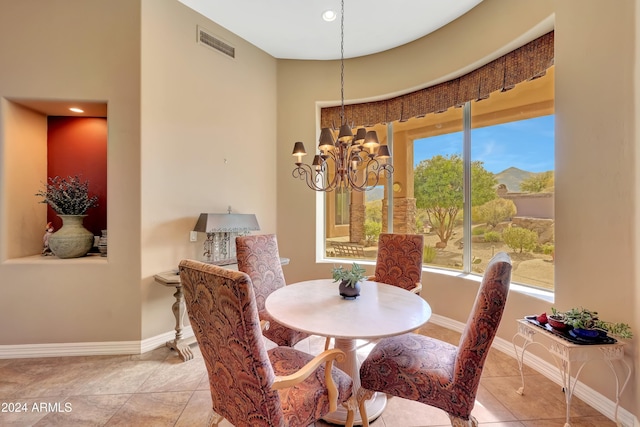 dining space featuring a chandelier and light tile patterned flooring