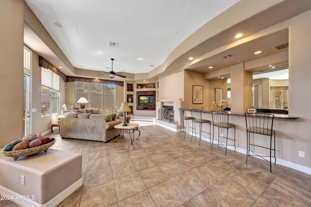 living room with ceiling fan and light tile patterned floors