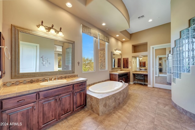 bathroom featuring vanity and tiled tub