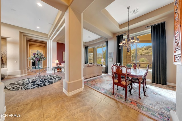 dining space with light tile patterned flooring and an inviting chandelier