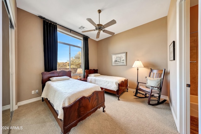 carpeted bedroom with ceiling fan and a closet