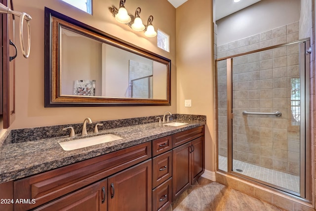 bathroom featuring tile patterned flooring, vanity, and an enclosed shower