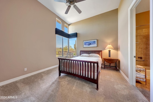 bedroom with high vaulted ceiling, ceiling fan, carpet floors, and connected bathroom