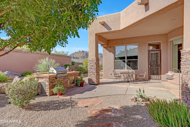 view of patio featuring a grill and exterior kitchen