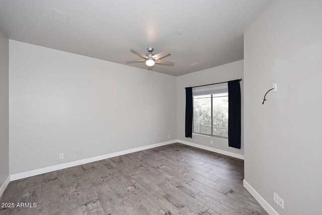 8180 E Shea Blvd Unit 1075, Scottsdale, AZ 85260 - spare room featuring baseboards, ceiling fan, and wood finished floors