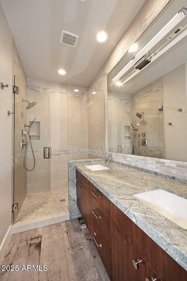 8180 E Shea Blvd Unit 1075, Scottsdale, AZ 85260 - full bathroom featuring a stall shower, wood finished floors, double vanity, and recessed lighting