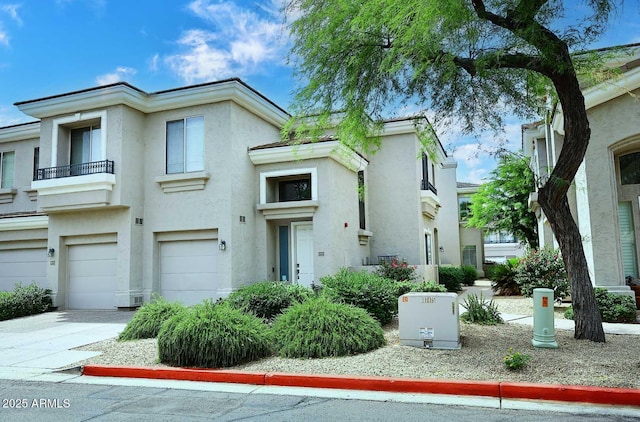 8180 E Shea Blvd Unit 1075, Scottsdale, AZ 85260 - view of front of home with stucco siding, concrete driveway, and an attached garage