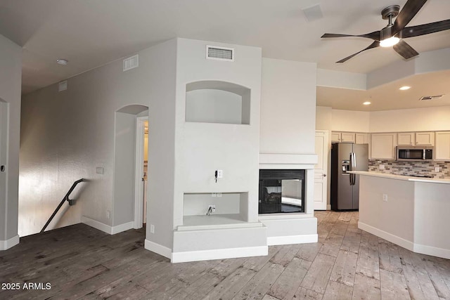 8180 E Shea Blvd Unit 1075, Scottsdale, AZ 85260 - kitchen with stainless steel appliances, light wood-type flooring, ceiling fan, recessed lighting, and tasteful backsplash