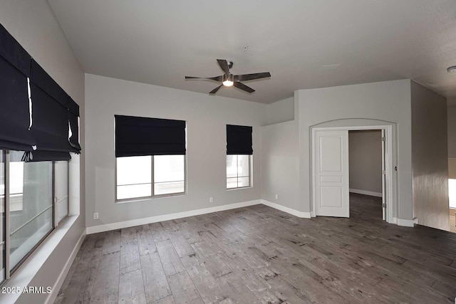 8180 E Shea Blvd Unit 1075, Scottsdale, AZ 85260 - empty room featuring ceiling fan, dark wood-style flooring, plenty of natural light, and baseboards