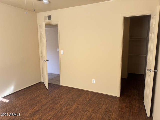 unfurnished bedroom featuring dark wood-type flooring