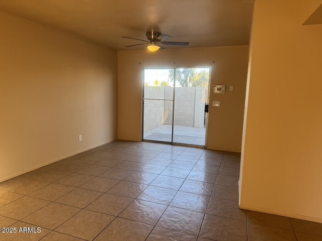 tiled spare room with ceiling fan