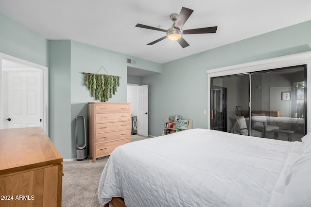 bedroom featuring light colored carpet, a closet, and ceiling fan