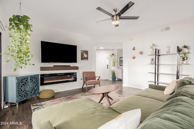 living room featuring dark hardwood / wood-style floors and ceiling fan