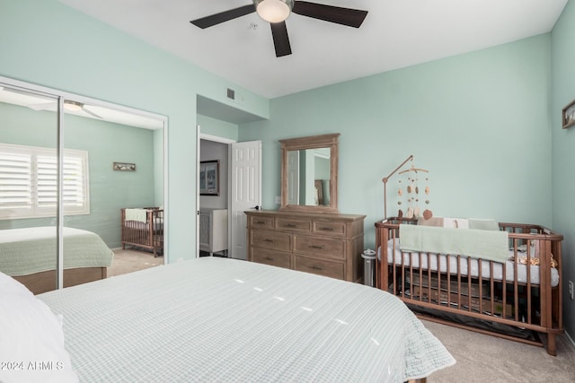 bedroom featuring light carpet, a closet, and ceiling fan