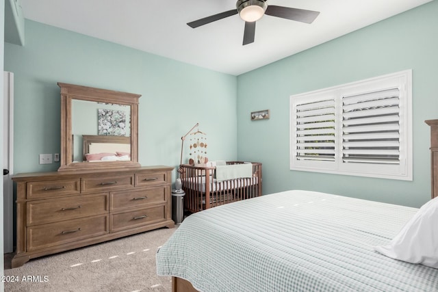 bedroom with ceiling fan and light carpet