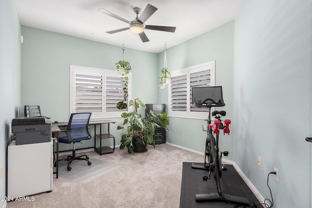 carpeted office space with ceiling fan