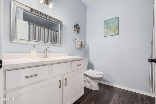 bathroom with vanity, toilet, and wood-type flooring