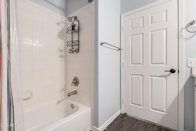 bathroom with hardwood / wood-style floors and shower / bath combo