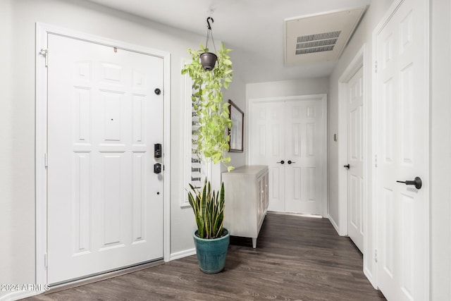 foyer entrance with dark hardwood / wood-style floors