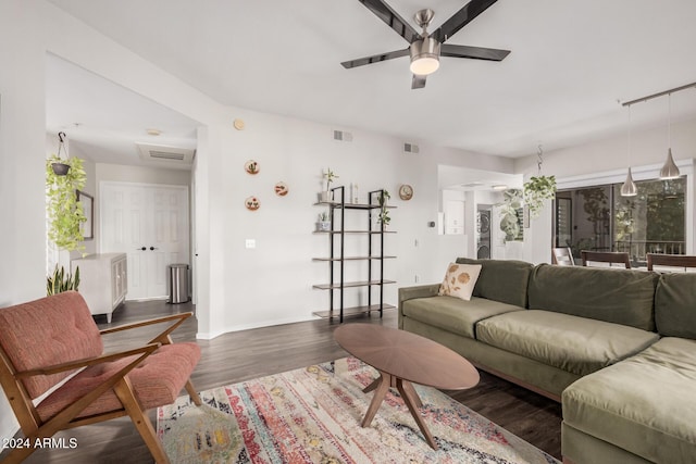 living room featuring ceiling fan and dark hardwood / wood-style flooring