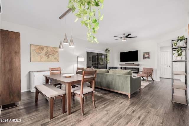 dining room with ceiling fan and dark wood-type flooring