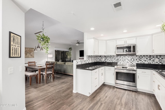 kitchen with white cabinets, stainless steel appliances, and dark wood-type flooring