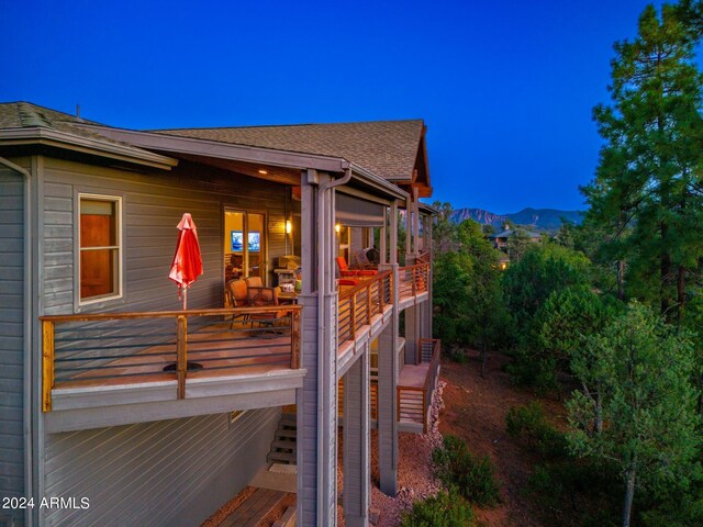 deck at twilight featuring a mountain view