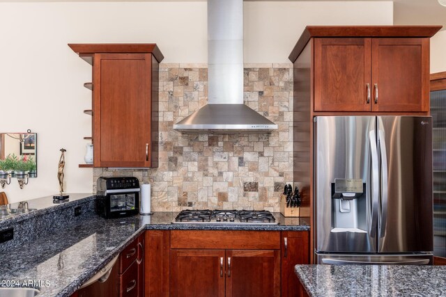 kitchen with dark stone countertops, backsplash, and stainless steel appliances