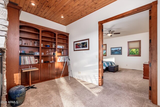 carpeted home office featuring ceiling fan and wooden ceiling