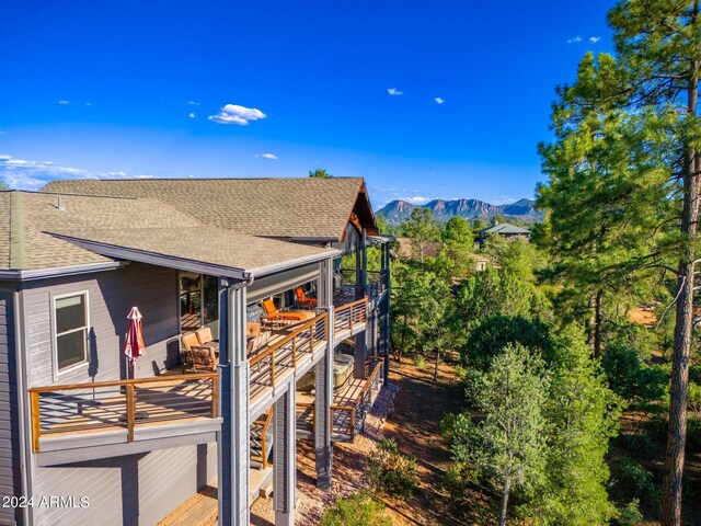 view of side of home with a deck with mountain view