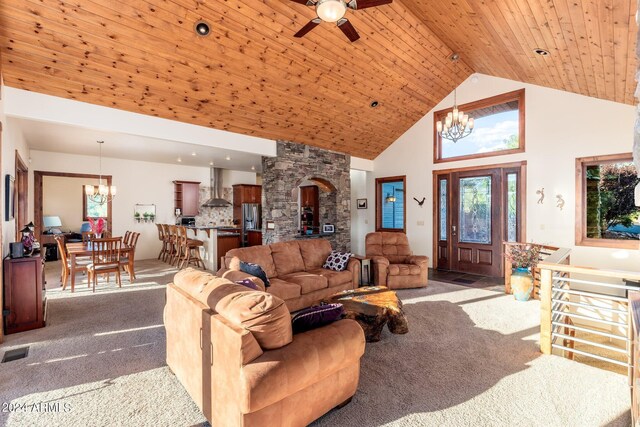 living room with ceiling fan with notable chandelier, a wood stove, carpet, wood ceiling, and high vaulted ceiling