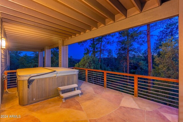 patio at twilight with a hot tub