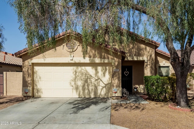 view of front facade featuring concrete driveway, a tiled roof, an attached garage, and stucco siding