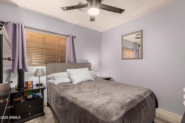 bedroom with a ceiling fan and wood finished floors