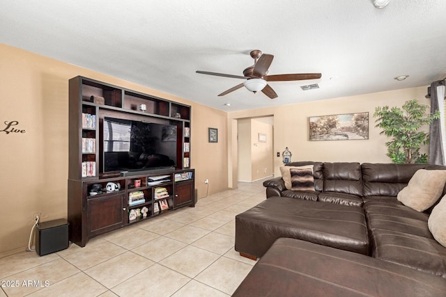 living room with light tile patterned floors, visible vents, and a ceiling fan