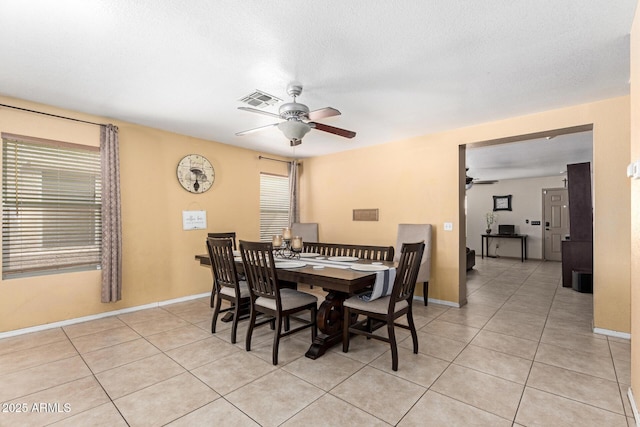 dining area featuring a ceiling fan, visible vents, and light tile patterned floors