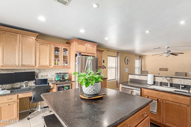 kitchen with a kitchen island, a sink, appliances with stainless steel finishes, tasteful backsplash, and glass insert cabinets