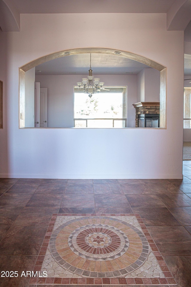 interior space with a notable chandelier and baseboards