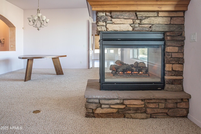 room details with arched walkways, a fireplace, and carpet flooring