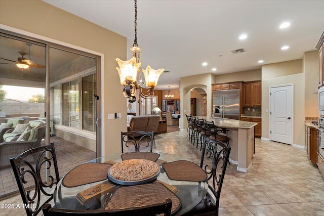 3350 S Holguin Way, Chandler, AZ 85248 - dining space featuring a chandelier, arched walkways, ceiling fan, recessed lighting, and light tile patterned flooring